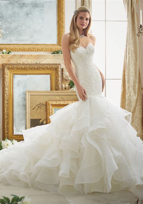 This dress uniquely flares outwards from the knee to create a modern and dramatic line. Lace and Tulle and Organza Mermaid Wedding Dress | Morilee