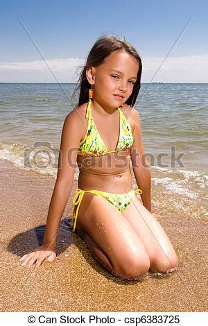 Little girl sitting at the beach. Little girl sitting at ...