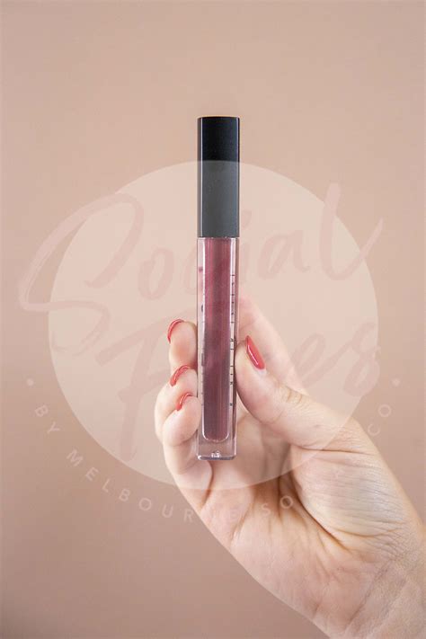 See more ideas about dark beige, beige, tom holand. Dark red liquid lipstick in hand on beige background ...