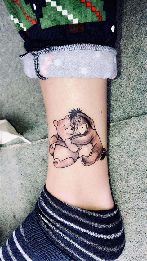 A smile and a jig on lower leg. 15+ Amazing Winnie The Pooh Tattoo Designs | PetPress