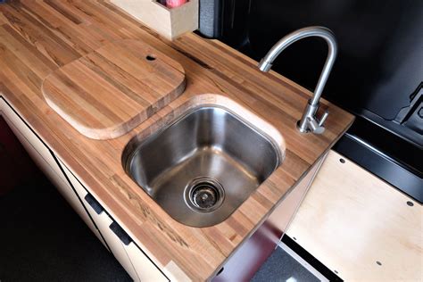 Before unclogging kitchen sinks with standing water, use a cup or basin to remove the water. Nice butcher block sink cover | Van conversion interior ...