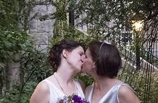 kissing brides two wedding garden