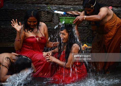 Nepalese Hindu women take a ritual bath in the Bagmati river during ...