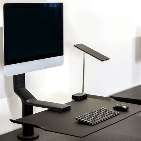 This tray slides out from under the desk top and rests on my wheelchair armrests, providing support at just the right height for shoulder comfort. Under Desk Computer Stand | QuickStand Under Desk | Humanscale