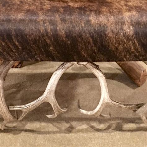 Check out our cowhide bench selection for the very best in unique or custom, handmade pieces from our chairs & ottomans shops. This is a real cowhide and antler bench.
