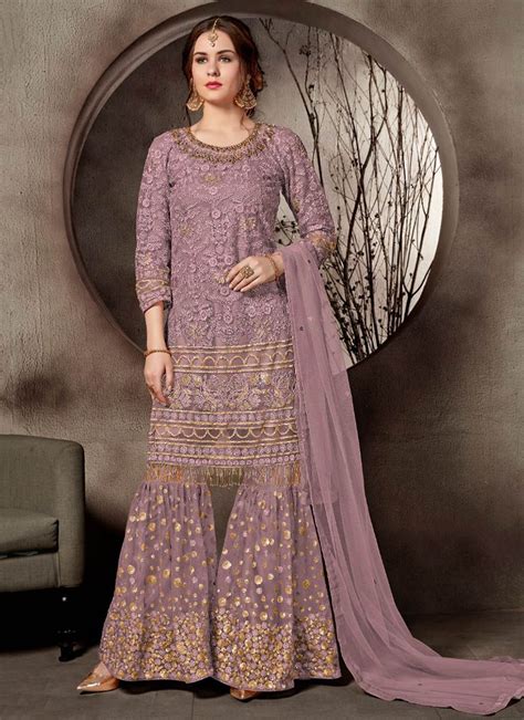 All of salaam's clothing line is cut and sewn in manhattan from hand selected european fabrics with bold and colorful print wedding wear purple net heavy embroidery work sharara suit ...