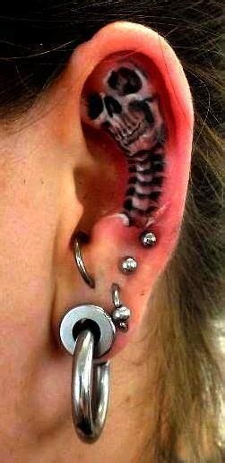 Girls prefer tattoos that enhance their personality, beauty and femininity. Small Skull Ear Tattoo | Ear tattoo, Funky tattoos, Face ...