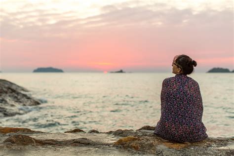 Lonely woman sitting on the seashore after sundown. - Bladder Cancer Advocacy Network