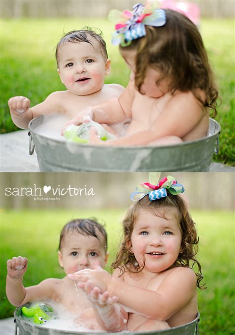 Young woman with red hair take bubble bath with candle. post cake smash bubble bath with sister, sibling photo ...