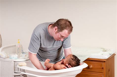 Newborn getting cleaned in hospital. Father Getting His Baby Out Of The Bath Stock Photo ...