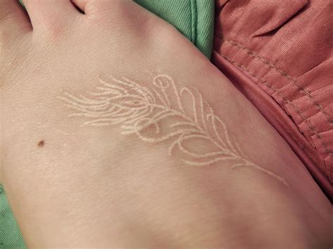 The peacock tattoo can be representative of rebirth, spiritual evaluation, or creativity, and look amazing on the ribs, lower back, or the neck. My white ink peacock feather tattoo (if i ever get brave ...
