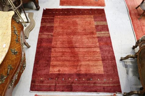 Complementary blue creates a focus in the paired artwork on the wall and brings in a cool note of color to balance the warmth of orange. Sold Price: Two tone red carpet with pattern, approx 185cm ...