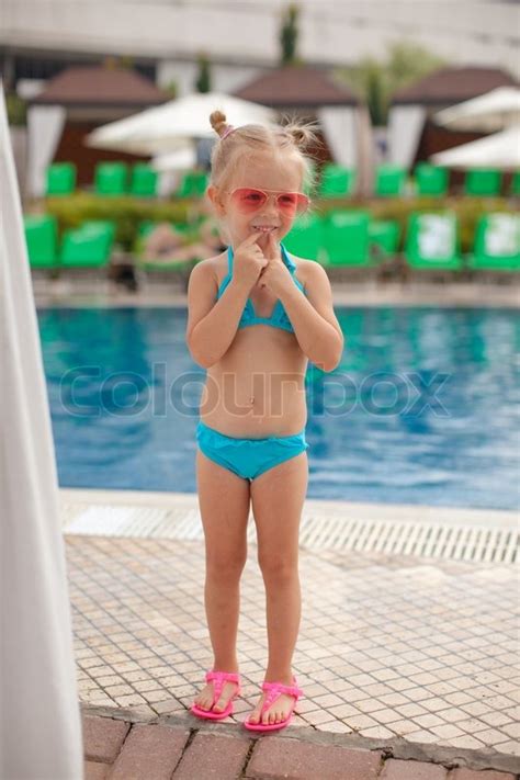 The gym bro's don't get to see, but i'll show reddit what's underneath. Cute little girl standing alone near swimming pool | Stock ...