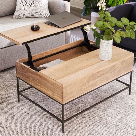 It's equipped with an open shelf and a roomy drawer, giving you plenty of space for both display and storage. Industrial Storage Pop-Up Coffee Table | West Elm