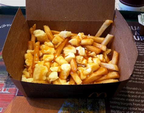 Poutine poutine with cheese curds on top of fries covered with a thin gravy origin place of origin. All You Need To Know About McDonald's Poutine | News