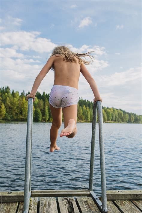 Skinny, short hair and limp. kids run and jump and skinny dip in a lake in the late ...