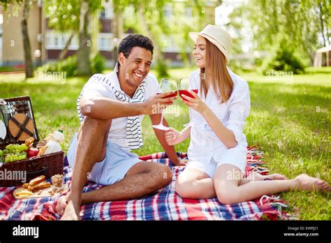 Happy young couple having picnic in park Stock Photo: 84704985 - Alamy