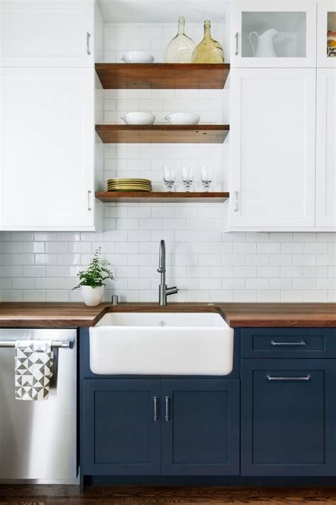 That is also in great harmony with the lighting fixture on top of the island and white kitchen backsplash. Dark base cabinets, white top cabinets. Open wood shelves ...