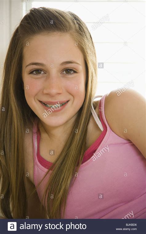 + busty pigtail teen masturbates 7 min. Girl with braces on bed with hairbrush smiling Stock Photo ...