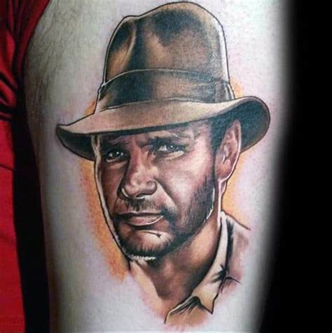 The tattoo on his right arm says nora, his daughter. 60 Indiana Jones Tattoo Ideas For Men - Dr Henry Walton Designs