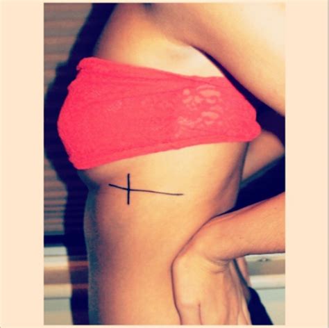 A dark feather tattoo that contrasts well with fair skinned women. Simple cross tattoo on my ribs | Tattoo Ideas... | Pinterest
