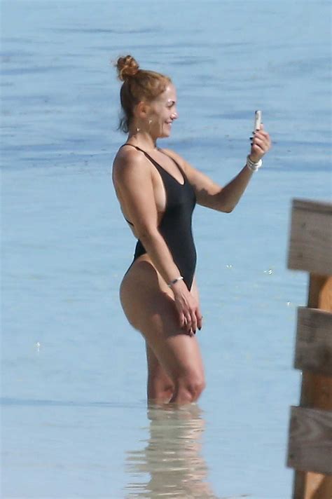 ✨ jlo beauty is available now! Jennifer Lopez in a Black Swimsuit Goes Paddle-Boarding on ...