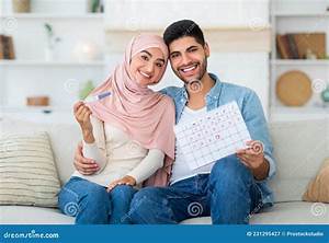 Loving Islamic Couple Holding Positive Pregnancy Test And Ovulation