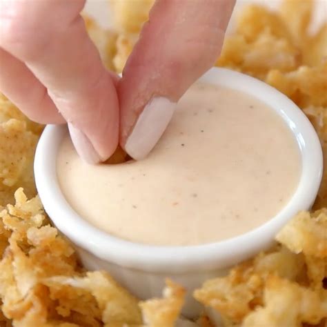 Maybe you would like to learn more about one of these? Bloomin Onion - this is a closeup photo of dipping a piece ...