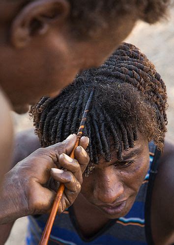 Unique packing gel styles for afro bun : Afar man having a traditional hairstyle with a stick to ...