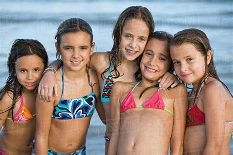Busty amateur girlfriend gets double teamed with facial. Hispanic girls in bikinis posing on beach - Stock Photo ...