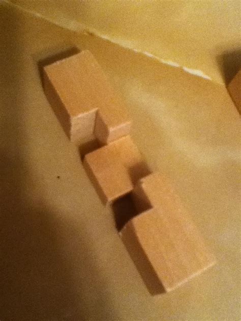 Here's how to solve the twelve piece wooden puzzle that looks like a square. 3D wooden puzzle - Puzzling Stack Exchange