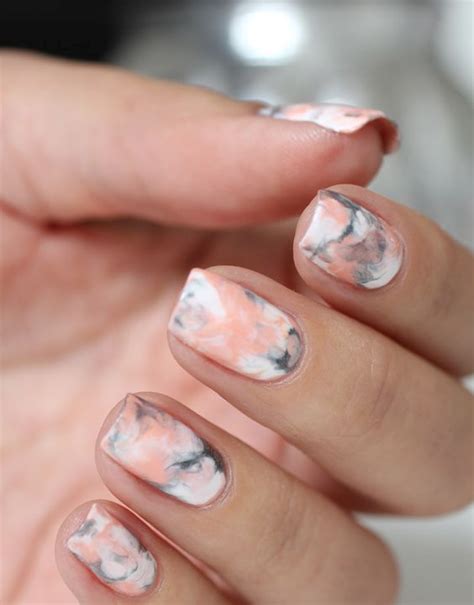 Marble nails are a kind of nail art design which imitates the appearance of marble. Picture Of pink, grey and white marbelized nail design