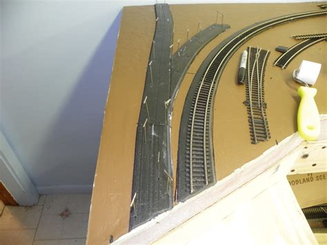 Flexi radka in latex outfit. Laying model train flex track with latex caulk