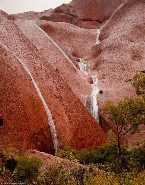 Heavy rain has created waterfalls off australia's famous uluru. Uluru visitors witness rare sight at Australian ancient ...