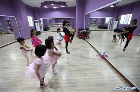 A dance instructor reported to be khing hnin wai appears to be unaware of the military coup happening behind her. Children practice ballet dance at Myanmar Ballet School in ...