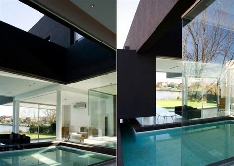 Modern house with garden swimming pool and wooden deck. A Black Modern House | Interior Design Ideas | AVSO.ORG