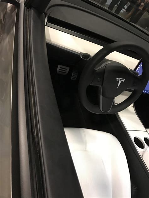 Tesla might have put it in the prototype in order to add another 'cool' factor to it, it does! silver-tesla-model-3-steering-wheel - TESLARATI