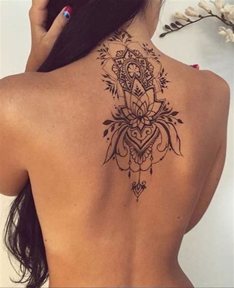 This black tattoo shows a pair of daisies growing over a bar of music and butterflies ascending from the lower back and up the wearer's back to the wearer's shoulder. Mytattooland.com: Back tattoos for women!