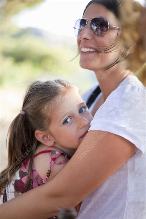 Mother hugging daughter outdoors - Stock Image - F004/3599 - Science 