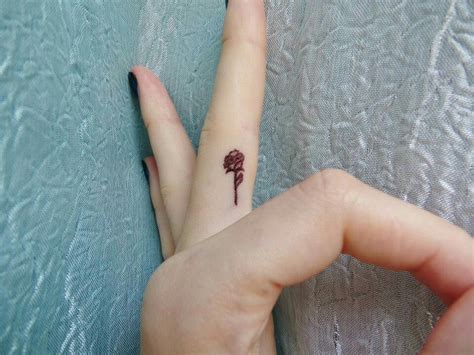 Yellow rose tattoo 99 photos 37 reviews tattoo 2006 s 900th the latest trend in tattoos is the roman. Rose finger tattoo | Tiny rose tattoos, Rose tattoos for ...