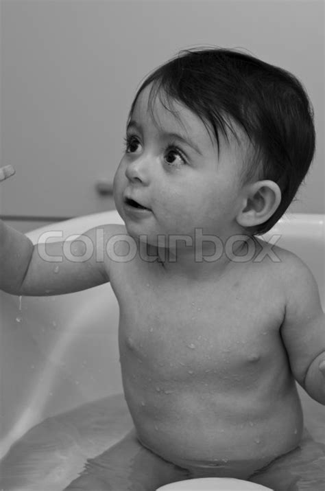 Position the gears side by side and pour over water to watch them spin. 1 Year Old Baby Girl Making Bath, Italy | Stock image ...