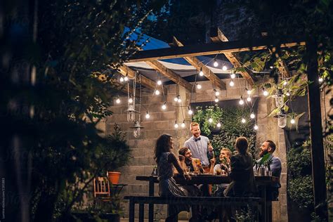The perfect dinner party game. Friends Having Fun At Outdoor Dinner Party by Lumina - Dinner