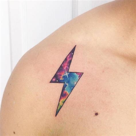 There is a red and blue lightning bolt tattooed on the inside of her left forearm. Galactic lightning bolt tattoo on the right shoulder.