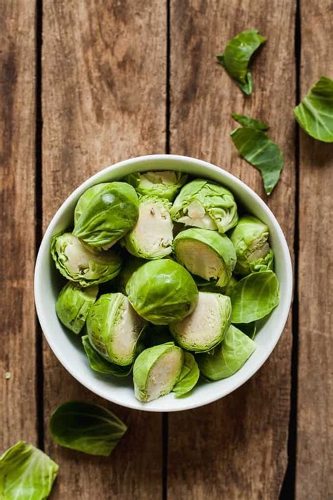 · wash and rinse the brussels sprouts. Brussels sprouts, trimmed and halved, in a bowl ready to ...