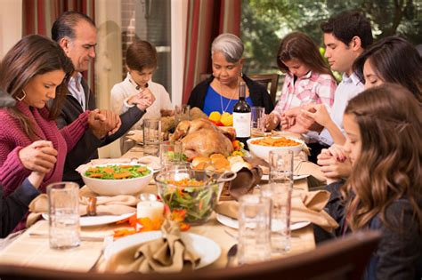 The hallowed family dinner we are so familiar with became accessible to all in the glorious consumer spending spree of the 1950s. Family Praying Before Thanksgiving Dinner At Grandmothers ...