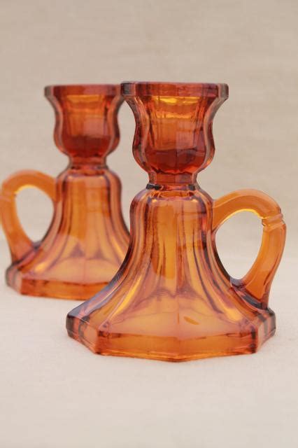 Our current inventory includes pieces in metal, brass, wrought iron, cast iron, glass, bronze, crystal and steel. vintage amber glass candle holders, small low chamber ...