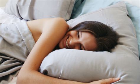 Young couple in pajamas, sitting on sofa side by side, eating popcorn, watching tv and kiss. Effective Strategies to Help You Sail into Dreamland (No ...