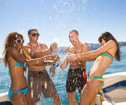 Yacht party with young people having a boat party, dancing on a bow of yacht deck. Party Boats Exclusively for Bachelor & Bachelorette Parties!