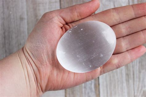 Selenite is a calming stone that instils deep peace and is excellent for meditation or spiritual work. One Selenite Palm Stone | Geoscape Rock Shop