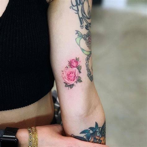 The completely blooming rose tattoos show the bold and confident side of women; Tiny Rose Tattoos That Will Be Blooming All Year Long